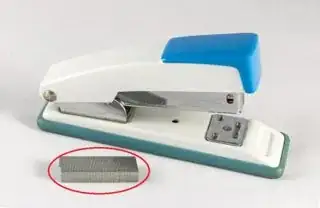 A stapler with staples next to it