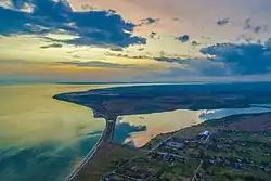 The western edge of the village (foreground), the Dnieper–Bug estuary (left) and lake (center right)
