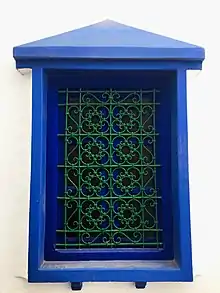 Image 47A window displaying a wrought iron window grill in Asila. The knots are tied with bent metal in the traditional way, rather than soldered. (from Culture of Morocco)