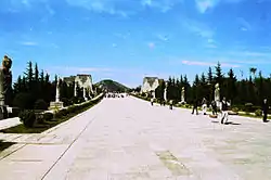 A view down the spirit way of the Qianling mausoleum of the Tang Dynasty. Remains of the third set of que towers are visible in the mid-distance. The stone platforms would originally have been topped with pavilion-like structures.