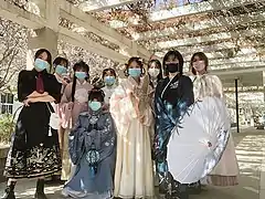 Hanfu enthusiasts holding a kite, a flower-shaped tuanshan, Chinese lantern, and an oil-paper umbrella as accessories, 2022