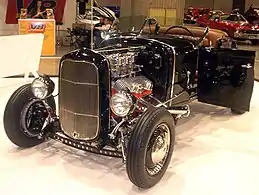 '31 A roadster with '32 grille shell (a common change), 3 deuces, Lake pipes, drilled I-beam, custom  windshield, custom drum brakes  with finned rear covers, & custom hairpins.