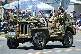 442nd Infantry Regiment veterans in a jeep at a memorial parade