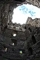 Partially destroyed stone tower. One can slightly guess the different floors that have now disappeared.