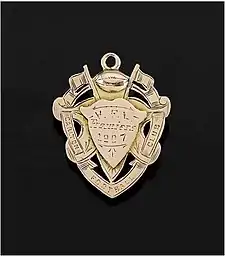 A medal inscribed with "Carlton Football Club, V.F.L. Premiers 1907"