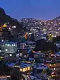 Informal settlements built into the hillside in Rocinha, Rio de Janeiro, Brazil at dusk