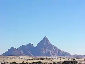 The Spitzkoppe of Namibia, a 670-metre (2,200&nbsp;ft) granite peak formed by early Cretaceous rifting and magmatism.