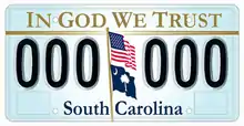 "In God We Trust" on the top of the optional license plate of South Carolina, designed in 2002. U.S. and South Carolina's flag appear weaving off a pole in the middle, separating two series of three characters each.