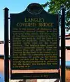 A photo of the Michigan Historical Marker placed on the bridge