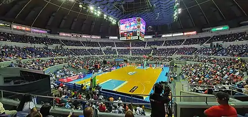 The view of the Coliseum from the Upper Box level, during the 2021 PBA season between the Barangay Ginebra San Miguel and the Magnolia Hotshots. The rivalry between the teams is often known as the Manila Clasico