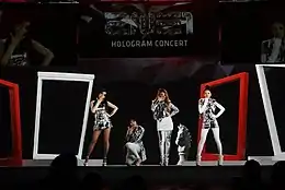 2NE1 onstage, in different poses