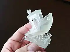 A 3DBenchy printed on a stereolithography 3D printer with support material still attached