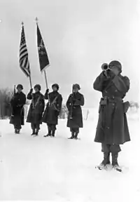 "Taps" at memorial ceremony for men of Company C, 9th Armored Engineer Battalion. Who were killed during siege of Bastogne, Belgium.