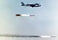 A U.S. Navy Grumman A-6E Intruder (BuNo 155592) aircraft as its crew monitors the flight of two AGM-123A low-level, laser-guided missiles
