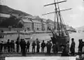 A group of men and boys standing on the quayside, Aberdyfi. Aberdyfi Regatta. John Thomas c. 1885