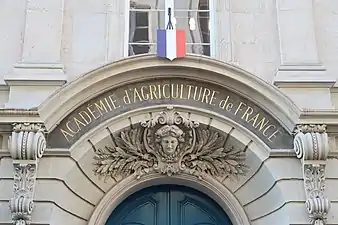 19th century Eclectic Classicist cartouche with a mascaron, above the entrance door of the Académie d'Agriculture de France in Paris