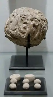 Globular envelope with a cluster of accounting tokens. Clay, Uruk period. From the Tell of the Acropolis in Susa. Susa II or "Uruk period"