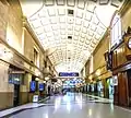 Along the station's concourse. Adelaide Casino is upstairs (left), platforms to the right. Ahead are a pedestrian tunnel under, and stairs up to, North Terrace.