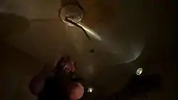 A man is being strangled by a tentacled creature