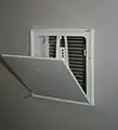Air transfer damper mounted in wall