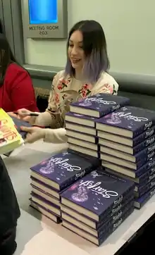 Bowman autographing a book at the American Library Association's (ALA) Youth Media Awards in 2018
