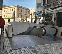 Entrance at Athanasiou Diakou street. The Parthenon is visible on the background.