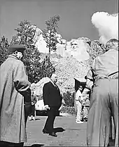 Image of Hitchcock pictured under Mount Rushmore during the filming of North by Northwest