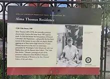 Sign with text in front on Thomas' residence