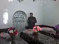 A visitor praying Al Fateha at the graves of tomb of Allo Mahar Shreef.
