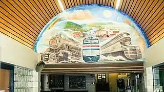 A mural located above the entrance to the ticketing/waiting area depicting the city's railroading past. It greets passengers arriving in Altoona on their way out of the station.