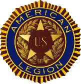 Five-pointed star with the insignia "U. S." enclosed in two bronze bands in the center of the star. This design is enclosed in a wreath. Encircling the star and the wreath are the words "American Legion" set in deep blue enamel. This in turn is encircled by a narrow band suggestive of the rays of the sun