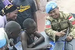 An Indonesian peacekeeper teaching the local population in Dungu, the Democratic Republic of the Congo