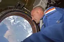 Dutch ESA astronaut Andre Kuipers looks out of the Destiny nadir window at Earth