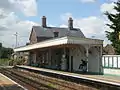 Closer view of the main station building and level crossing beyond.