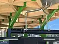 Detail of the wooden Anzac station entrance canopy, designed by Hassell, Weston Williamson and RSHP, during construction in 2022.
