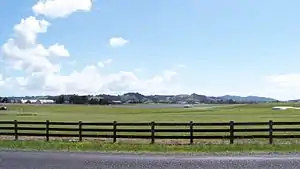 View of Ardmore Airport and surrounding farmland, backed by the Hunua Ranges.