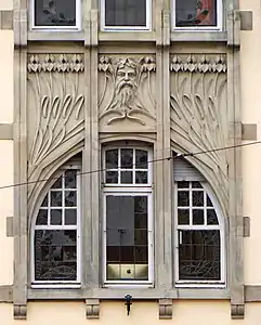 Irises and mascaron at the facade of Schichtel building by Aloys Walter in Strasbourg, France (1905–06)
