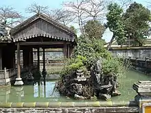 Pleasure garden in the residence of the imperial queen-mother. Hòn Non Bộ is installed in the lake