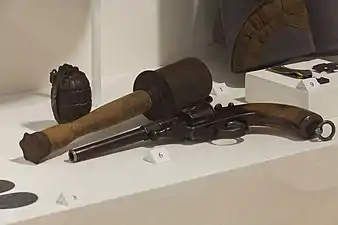 M17 grenade among a British Mills bomb grenade and a M1879 Reichsrevolver.