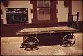 Baggage cart and timetable at the station in 1974.