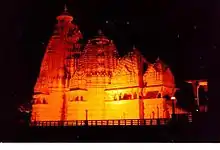 Temple with four rounded step levels, illuminated at night