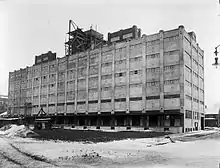 The Buffalo, Rochester and Pittsburgh Railway passenger station was south of the railroad tracks. The freight station, shown here in 1914 during construction, was built between the north side of the tracks and the Erie Canal at 25 Oak Street, opposite the passenger station.