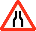 Road narrows on both sides
