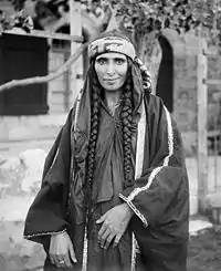 Image 8A Bedouin woman in Jerusalem, sometime between 1898 and 1914, dressed in Palestinian costume, the traditional clothing worn by Palestinians. Many of the handcrafted garments were richly embroidered and the creation and maintenance of these items played a significant role in the lives of the region's women. Until the 1940s, traditional Palestinian costumes reflected a woman's economic status, whether married or single, and the town or district of origin, and a knowledgeable observer could glean such information from the fabric, colors, cut, and embroidery motifs (or lack thereof) in a given woman's apparel.