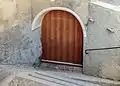 Old wooden door of a House on Plaz in Vnà.