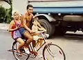 A family of three sharing a bicycle in 1994