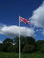 Flagpole of modest size, with simple truck