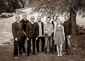 Big Big Train in 2014.Left to right: Andy Poole, Danny Manners, David Longdon, Rikard Sjöblom, Nick D'Virgilio, Dave Gregory, Rachel Hall and Gregory Spawton