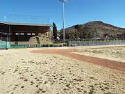 View of the concrete grandstand and home plate in the field of the Warren Ballpark.