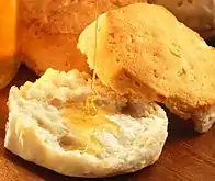 Open biscuit with honey being drizzled in it
